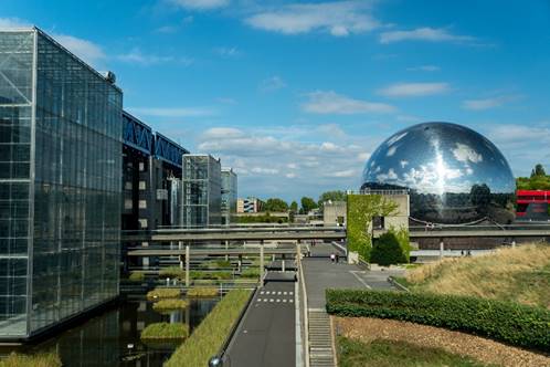 A large silver ball in front of a building
AI-generated content may be incorrect.